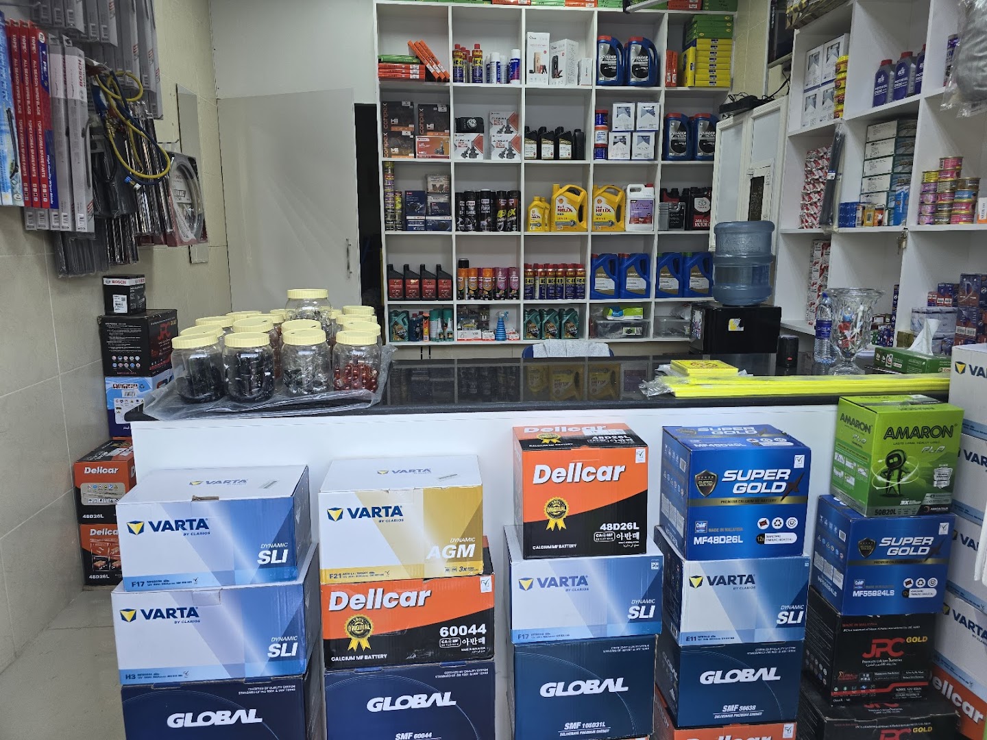 Counter stacked with Varta, Dellcar and Amaron car batteries